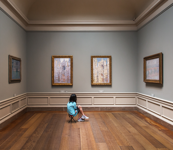 Picture of little girl sitting in front of paintings, National Gallery of Art, Washington D.C.